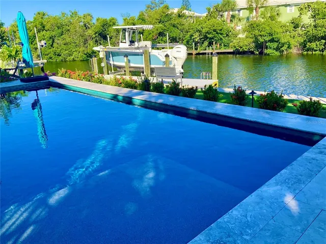 a living room with furniture a fireplace and a large window