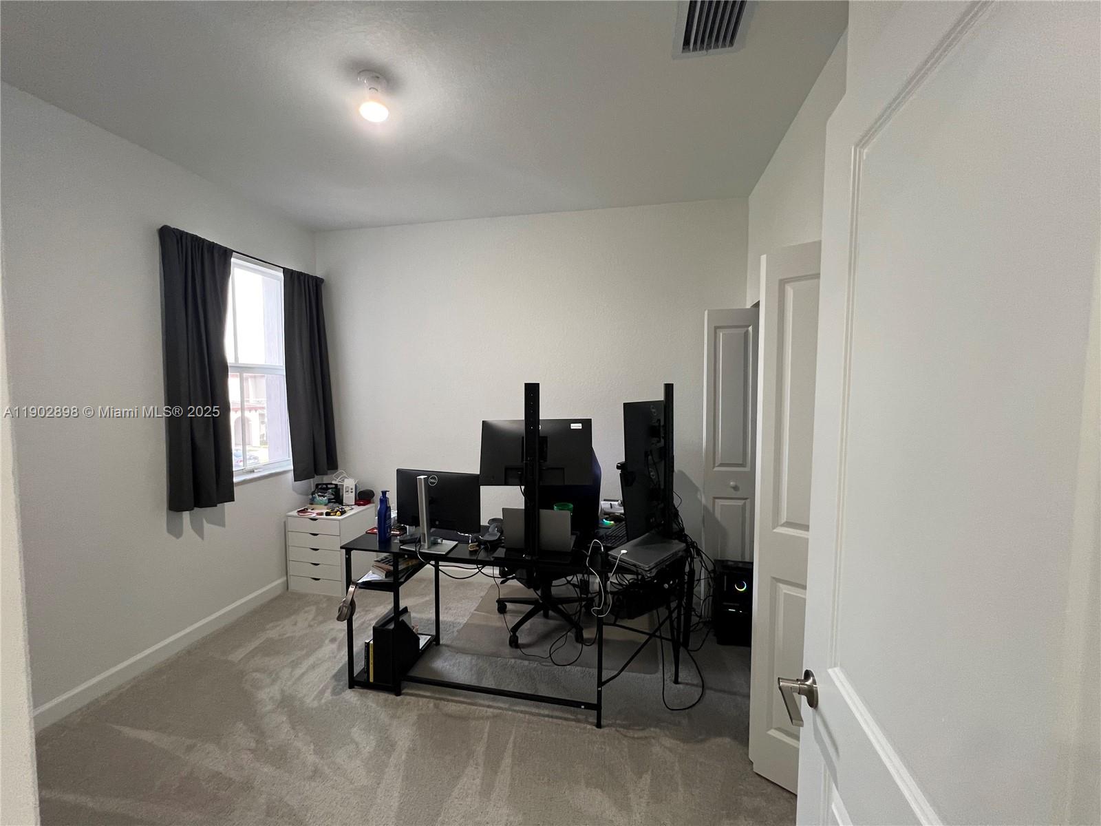 12142 Northwest 24th Court Miami, FL 33167 - Photo 11 of 20 a living room with furniture and a flat screen tv
