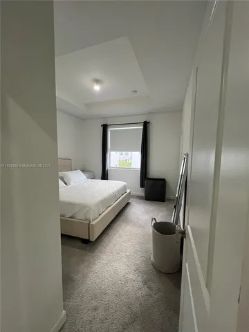 a large white bed in a white room