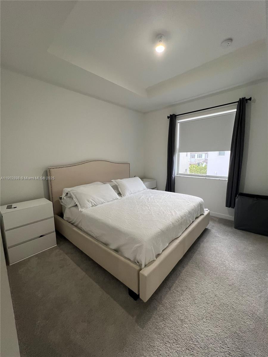 12142 Northwest 24th Court Miami, FL 33167 - Photo 14 of 20 a bedroom with a bed and a window