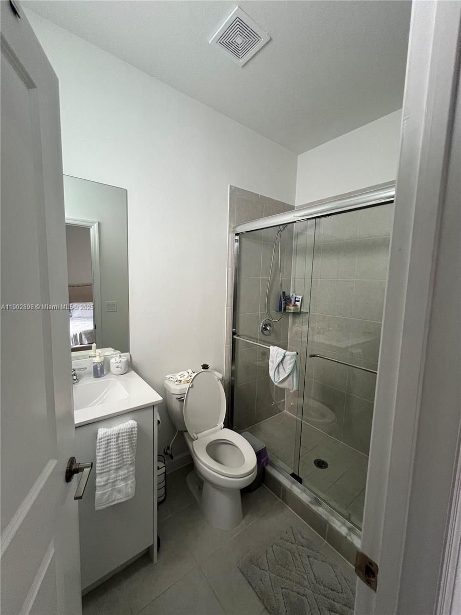 12142 Northwest 24th Court Miami, FL 33167 - Photo 16 of 20 a bathroom with a toilet sink and shower
