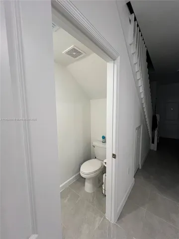a kitchen with refrigerator and chairs