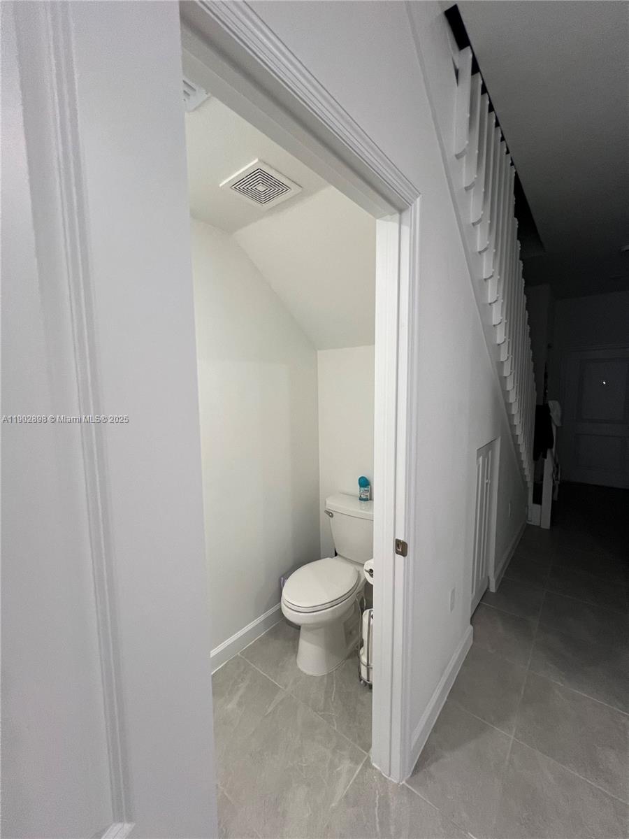 12142 Northwest 24th Court Miami, FL 33167 - Photo 17 of 20 a bathroom with a toilet and a shower