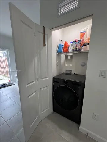 a kitchen with refrigerator a sink and cabinets