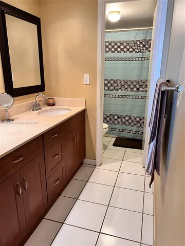 a bathroom with a double vanity sink a mirror and shower