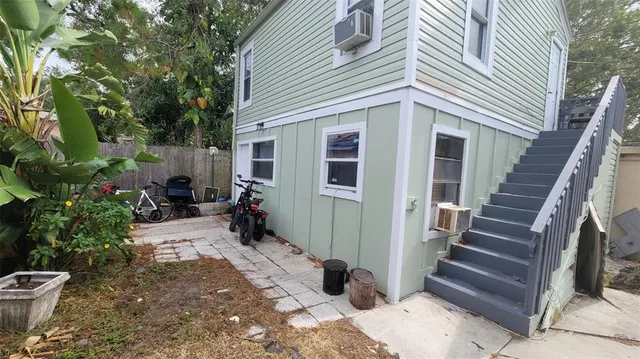 a view of a house with backyard and sitting area