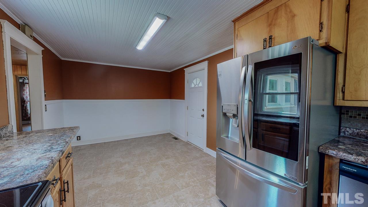 7089 Virgilina Road Roxboro, NC 27574 - Photo 11 of 28 a kitchen with a stove and a refrigerator