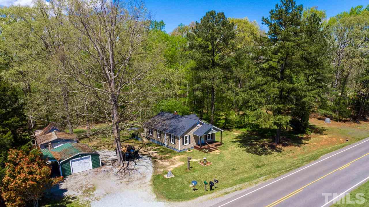 7089 Virgilina Road Roxboro, NC 27574 - Photo 27 of 28 a view of a garden with a house in the background