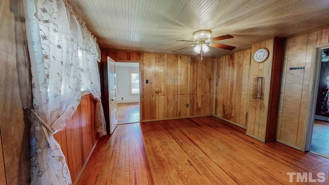 7089 Virgilina Road Roxboro, NC 27574 - Photo 5 of 28 a view of a hallway with wooden floor