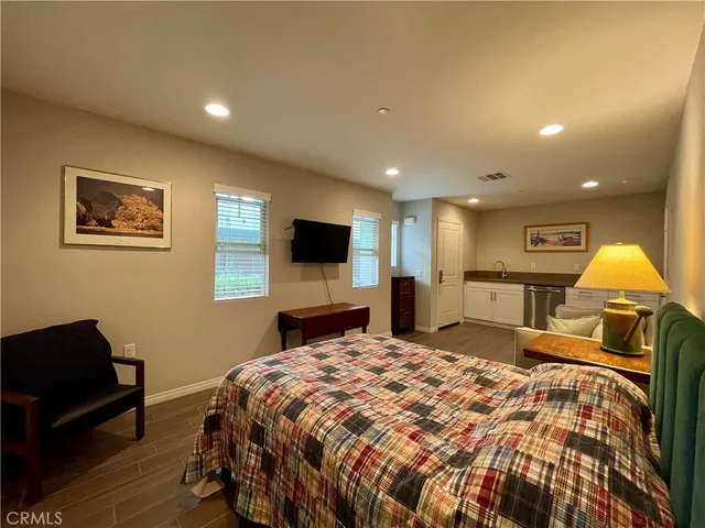 a bed room with a bed and a television