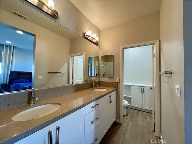 a bathroom with a granite countertop sink and a mirror