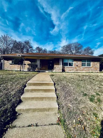 a view of a white house with a yard