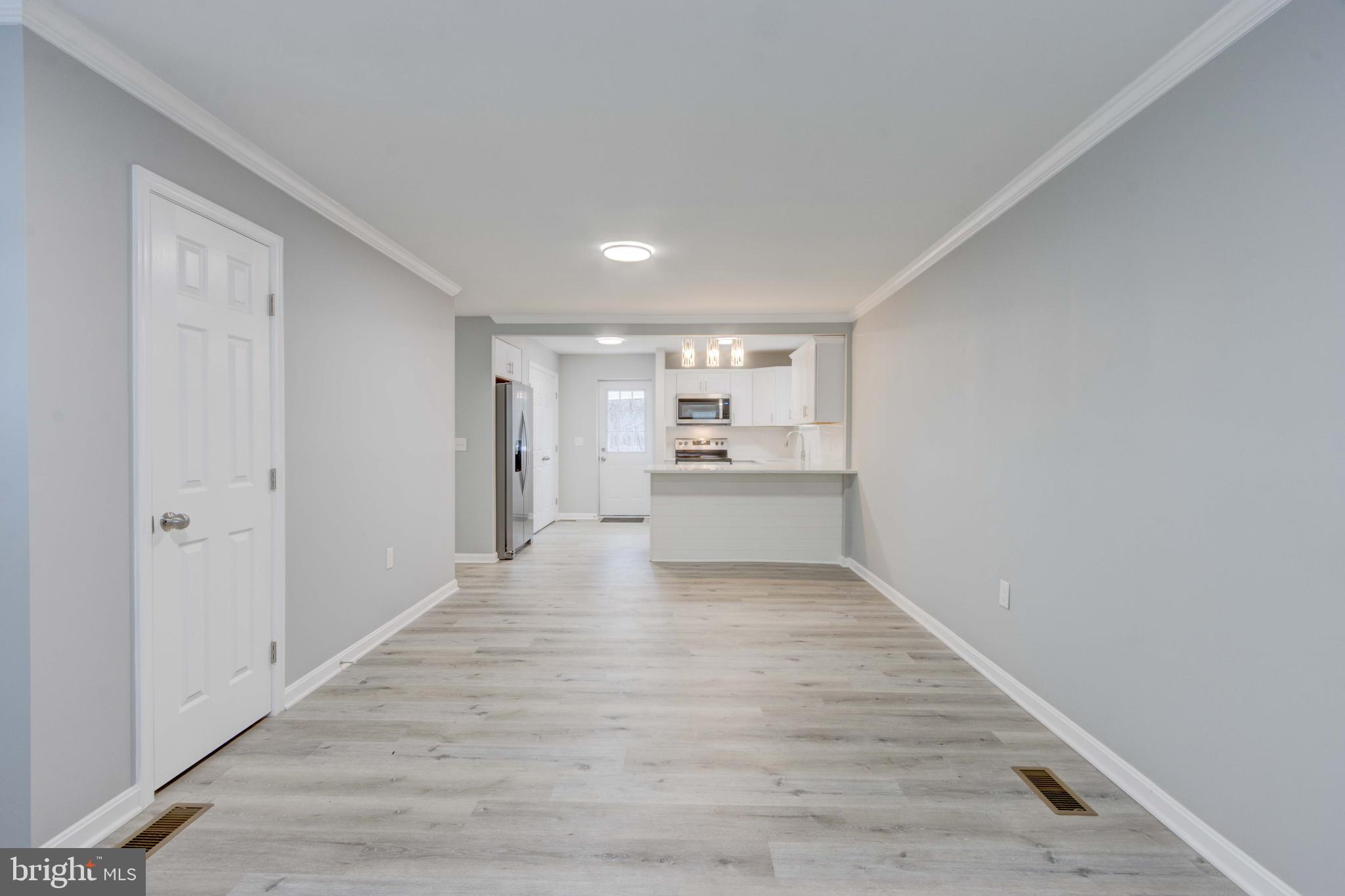 8149 Hog Neck Road Pasadena, MD 21122 - Photo 14 of 24 a view of kitchen with wooden floor