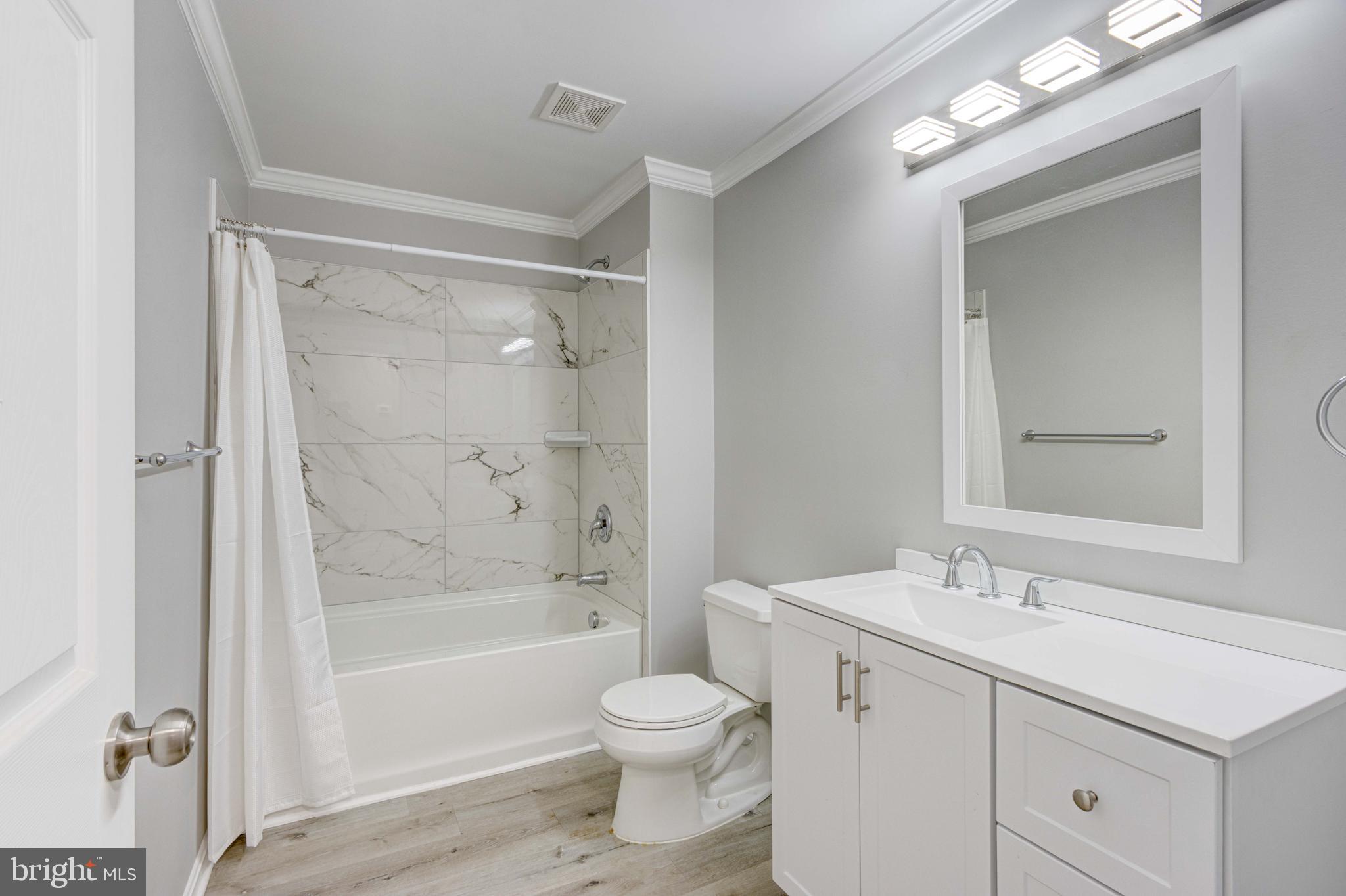 8149 Hog Neck Road Pasadena, MD 21122 - Photo 18 of 24 a bathroom with a sink a toilet and shower
