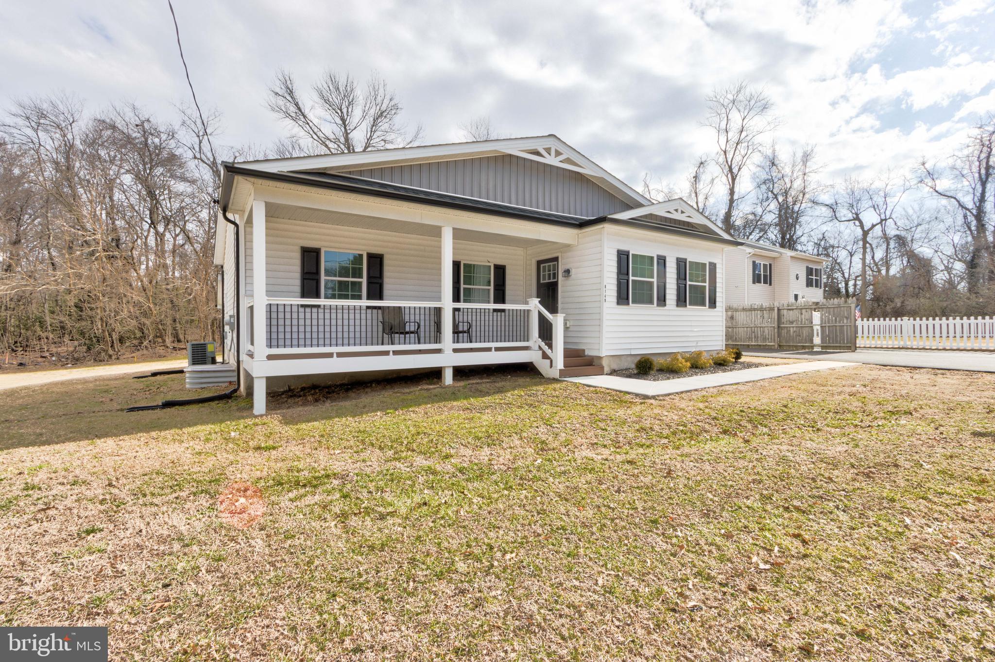 8149 Hog Neck Road Pasadena, MD 21122 - Photo 2 of 24 a front view of a house with a yard