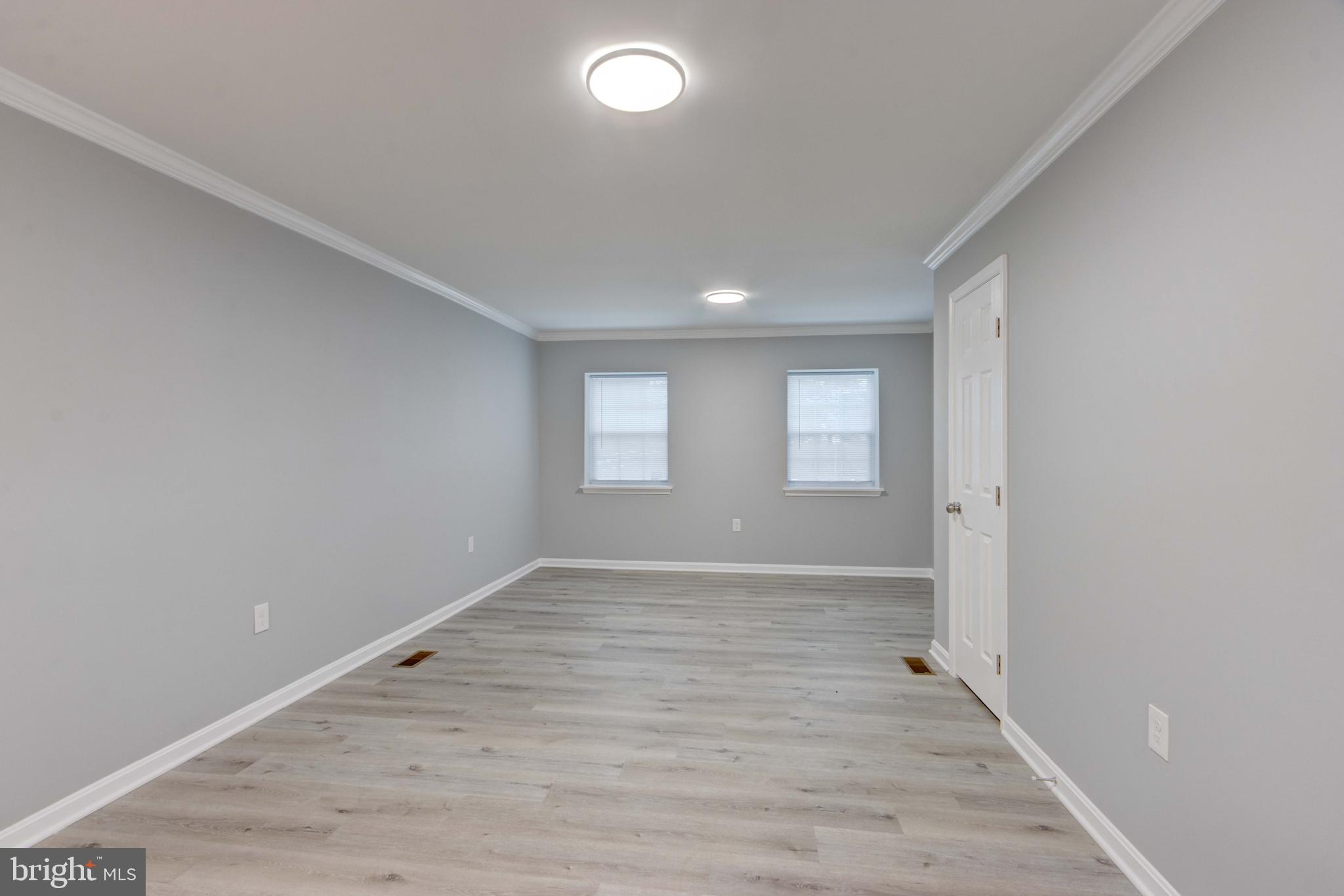 8149 Hog Neck Road Pasadena, MD 21122 - Photo 23 of 24 an empty room with wooden floor and window