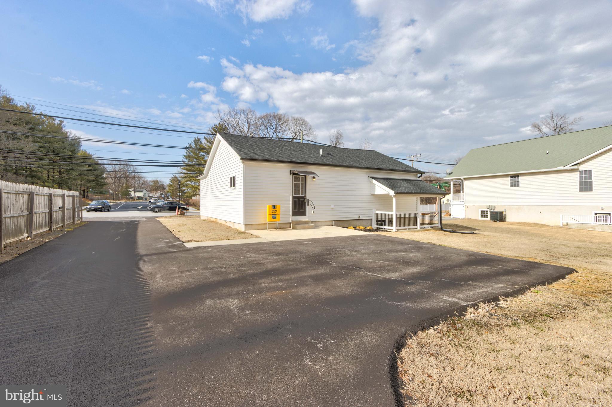 8149 Hog Neck Road Pasadena, MD 21122 - Photo 5 of 24 a view of a white house with a road