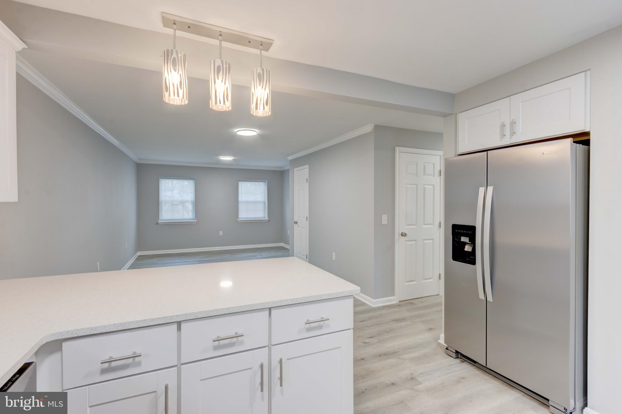 8149 Hog Neck Road Pasadena, MD 21122 - Photo 9 of 24 a room with a chandelier furniture and a chandelier