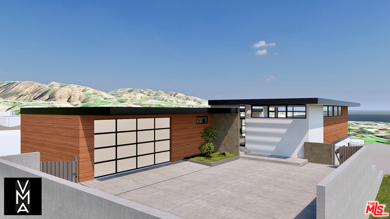 6756 Dume Drive Malibu, CA 90265 - Photo 3 of 17 a front view of a house with a yard