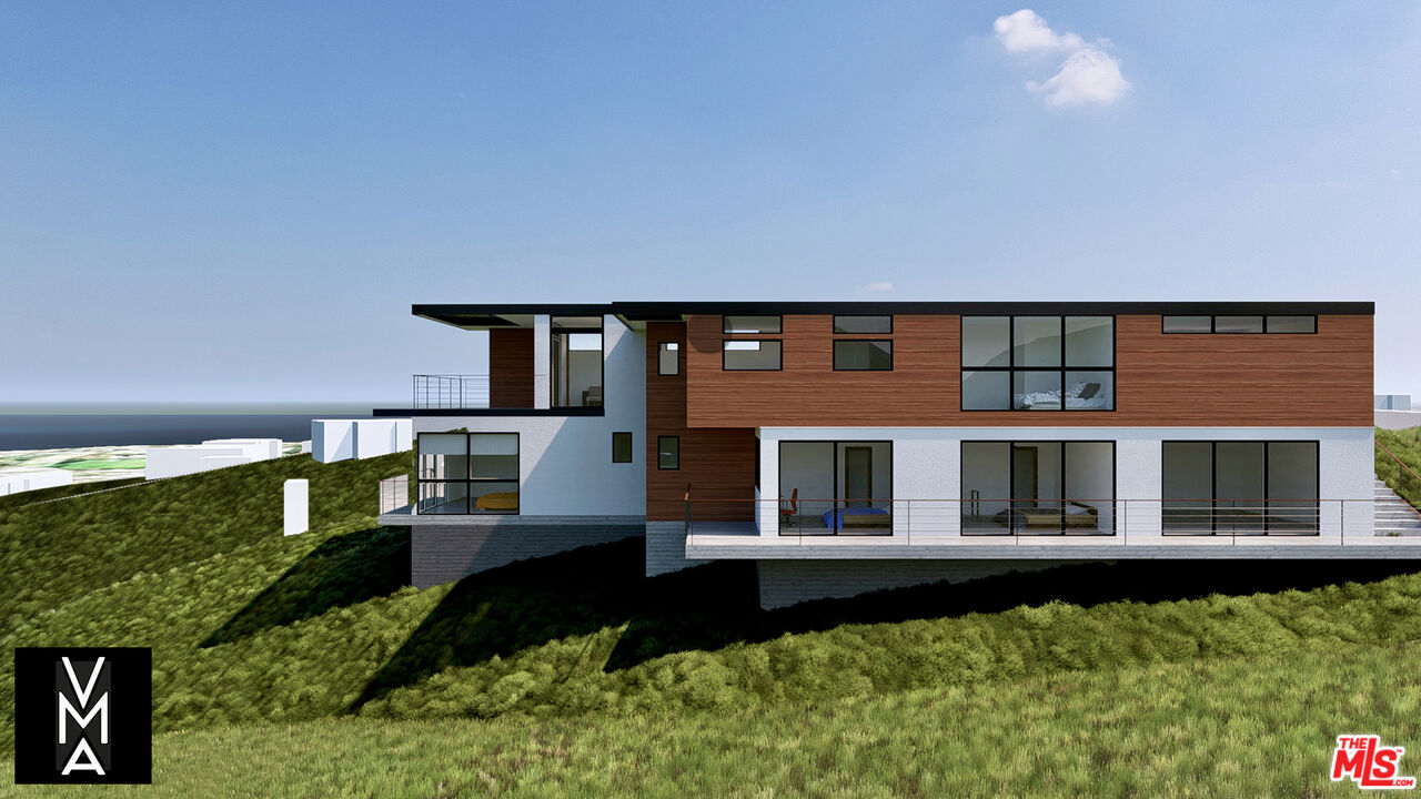 6756 Dume Drive Malibu, CA 90265 - Photo 4 of 17 a front view of a house with a garden