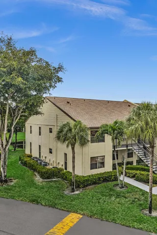 a living room with furniture a flat screen tv and a floor to ceiling window
