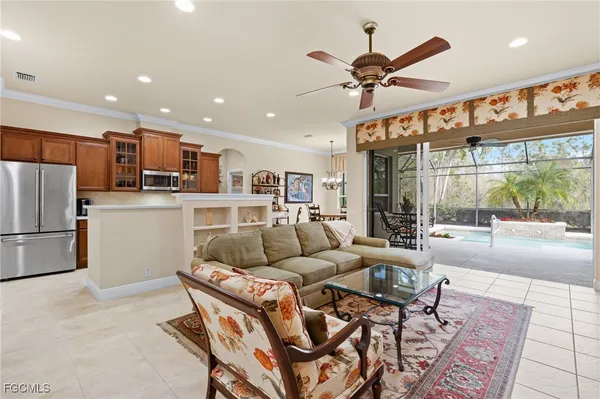 a living room with furniture and kitchen view