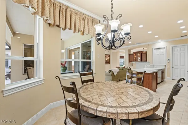 a view of a dining room with furniture and a chandelier