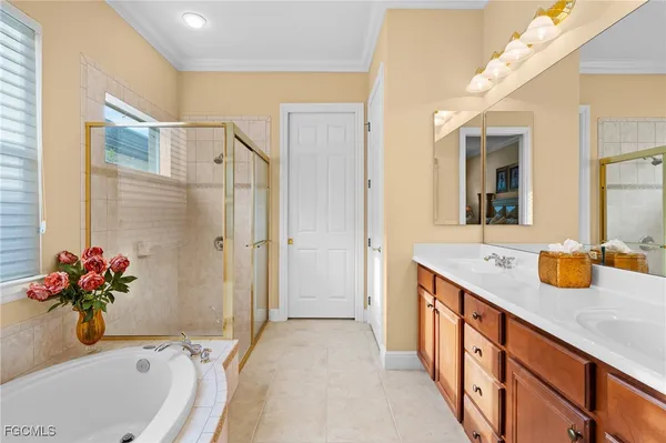 a bathroom with a tub sink and mirror