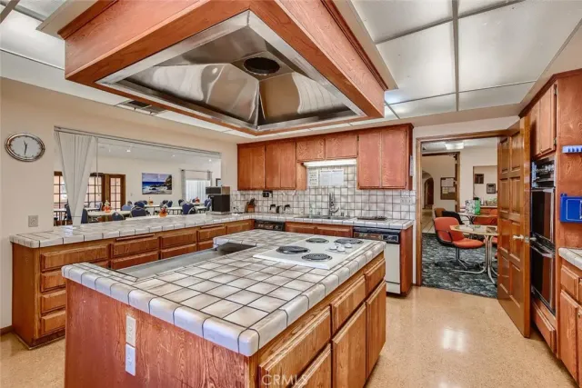 a kitchen with a stove a counter space and a sink