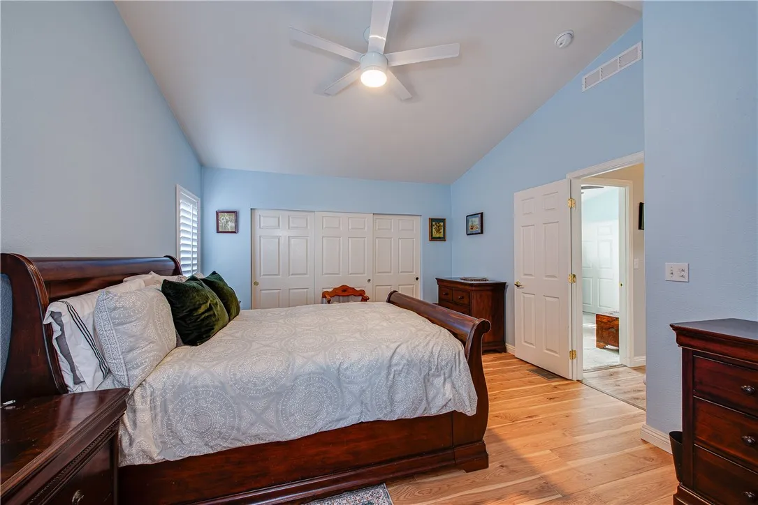 27250 Murrieta Road, Unit 304 Menifee, CA 92586 - Photo 6 of 29 a bedroom with a large bed and a chandelier