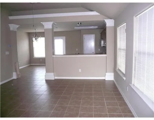 a view of a hallway with wooden floor and a living room