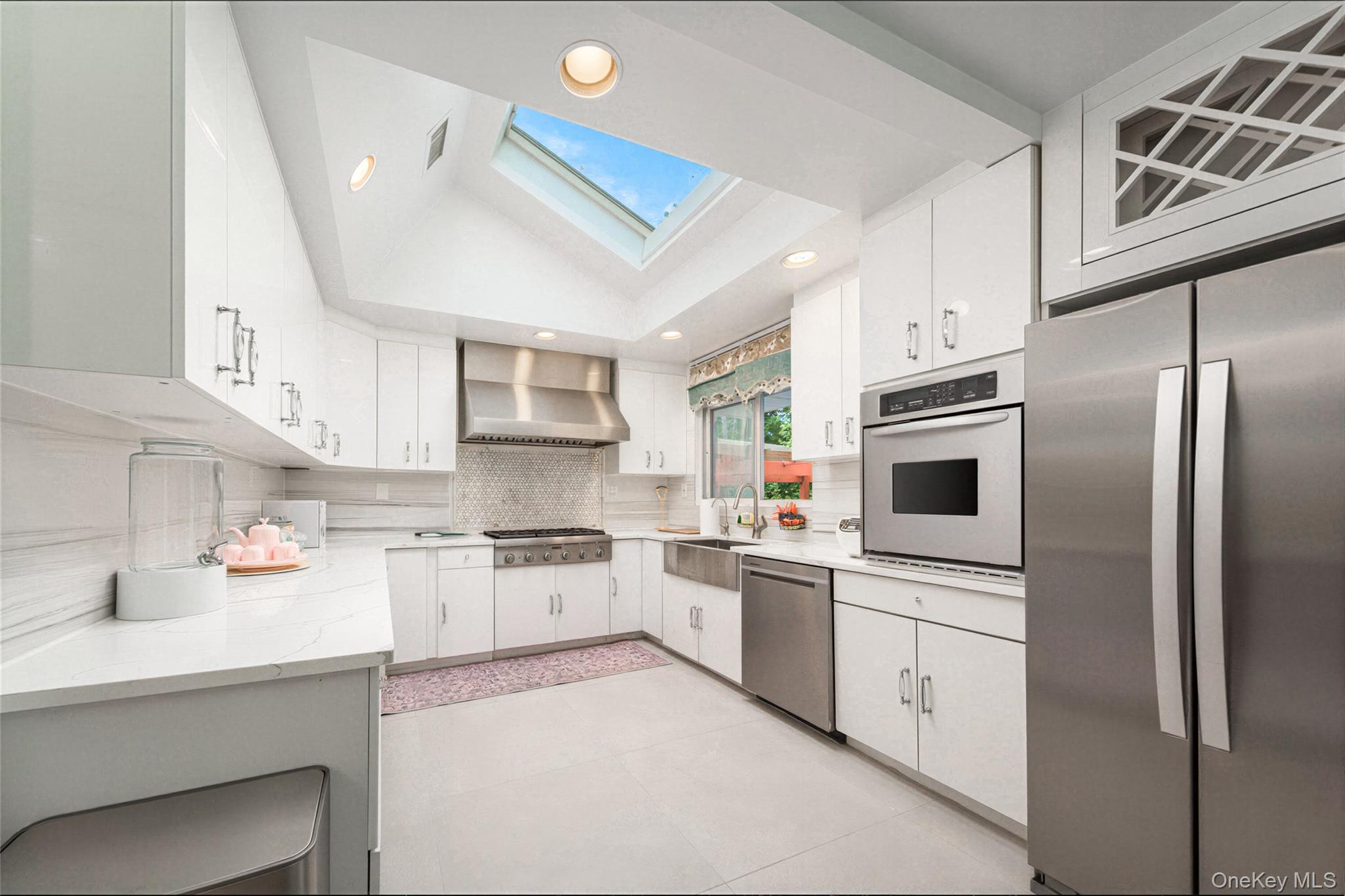 105 Seaman Road Jericho, NY 11753 - Photo 2 of 11 a kitchen with white cabinets and white appliances