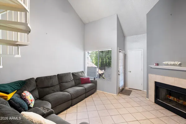 a living room with furniture a fireplace and a window
