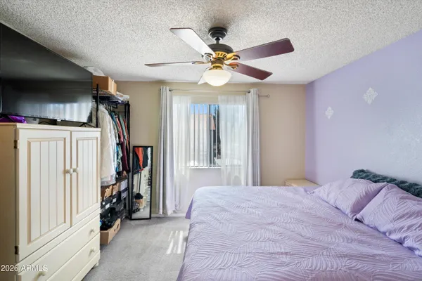 a bedroom with a large bed and a chandelier
