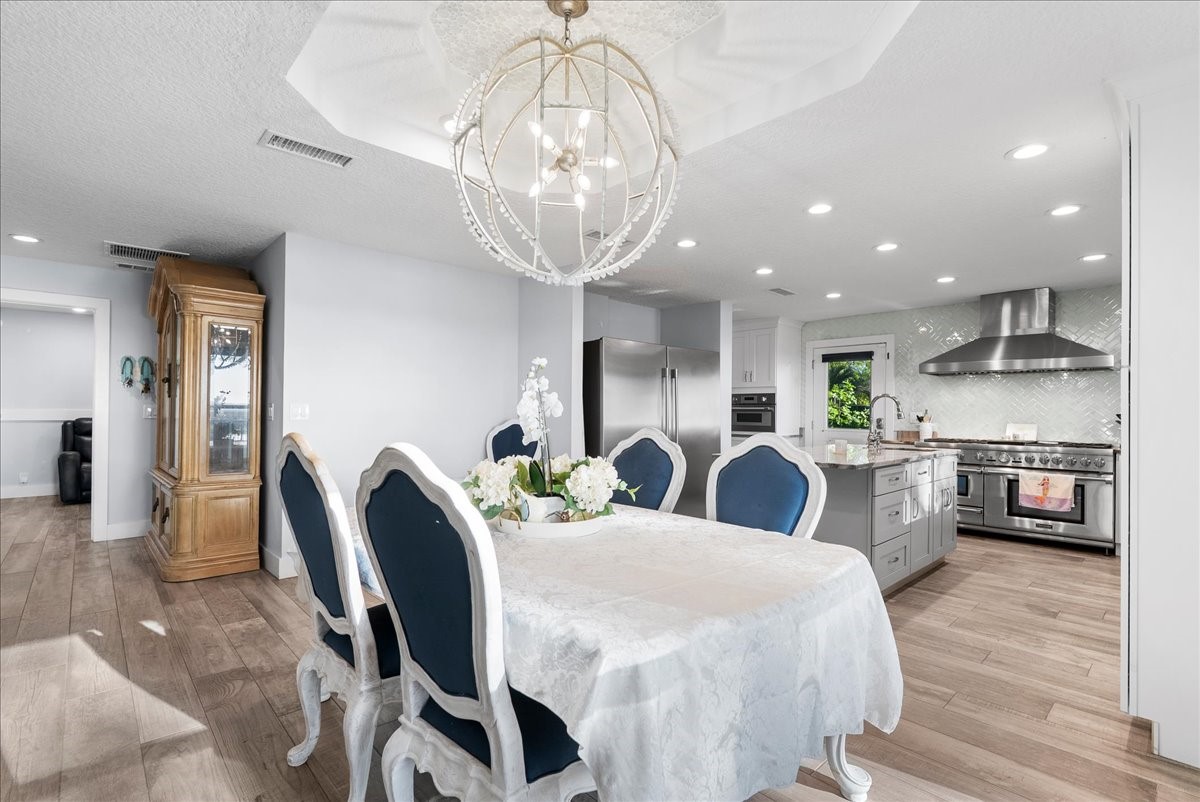 85316 Avant Road Yulee, FL 32097 - Photo 19 of 62 a large kitchen with stainless steel appliances couches chairs and stove