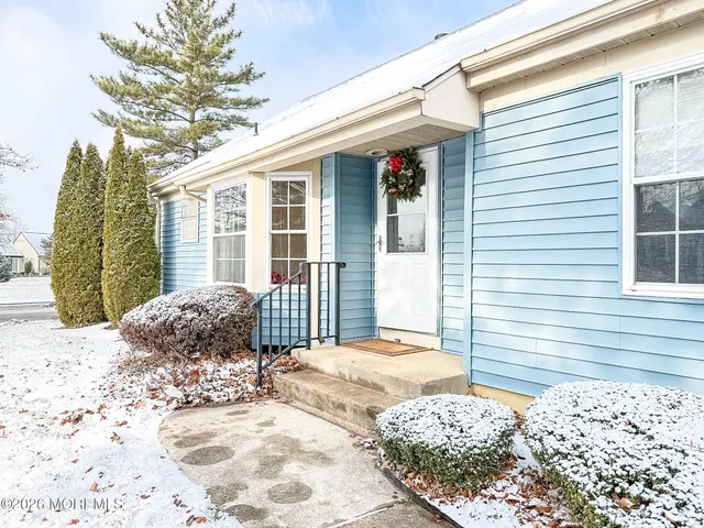 a view of a house with a snow on the road