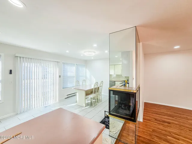 a view of an empty room with a fireplace and a window