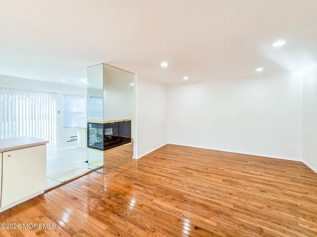 a kitchen with a sink a refrigerator and white cabinets