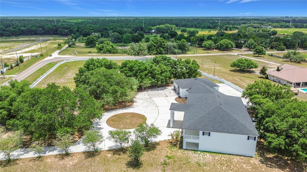 7925 Lake Mabel Loop Road Lake Wales, FL 33898 - Photo 96 of 97 an aerial view of a house with a swimming pool outdoor seating and yard