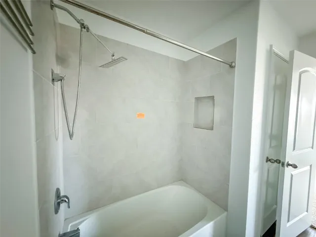 a bathroom with a tub and shower