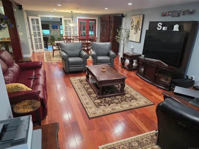 a living room with furniture and wooden floor