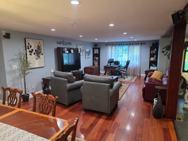 a living room with furniture and wooden floor