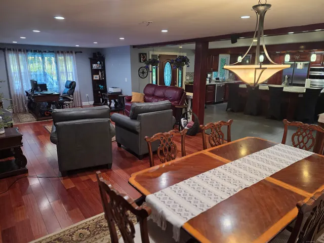 a living room with furniture pool table and a flat screen tv
