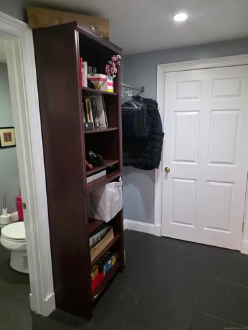 a bathroom with a toilet sink vanity and mirror