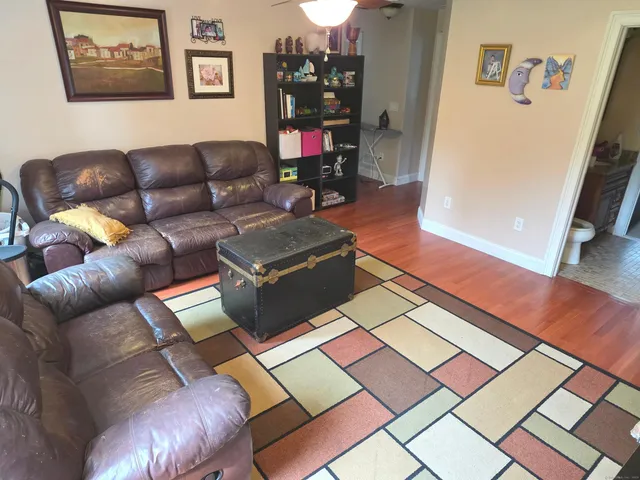 a bedroom with a bed and a flat tv screen on the dresser