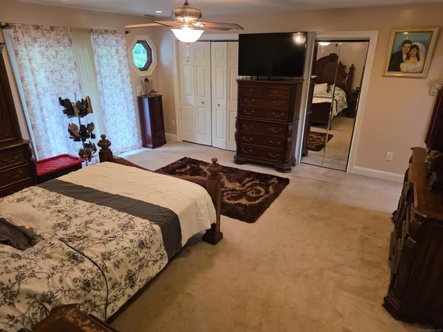 a bedroom with a bed and dresser