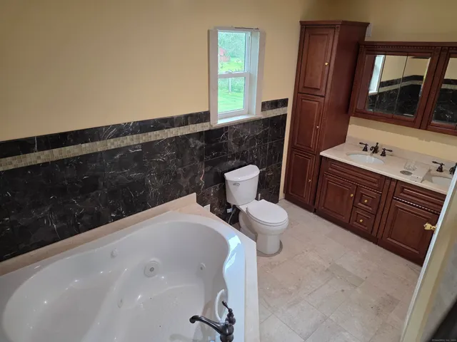 a bedroom with bed and a window