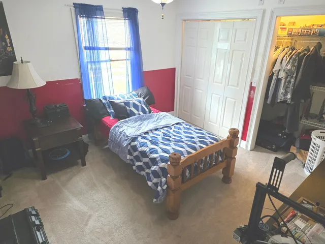 a bathroom with a granite countertop sink toilet and mirror