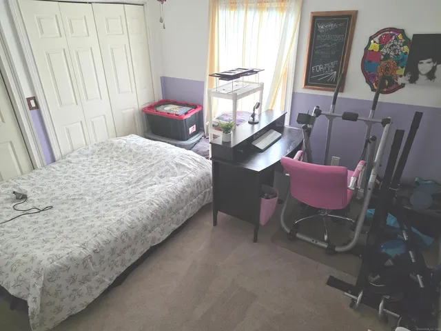 a bedroom with a bed dresser and a window