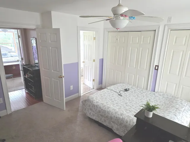 a bedroom with a bed and a mirror